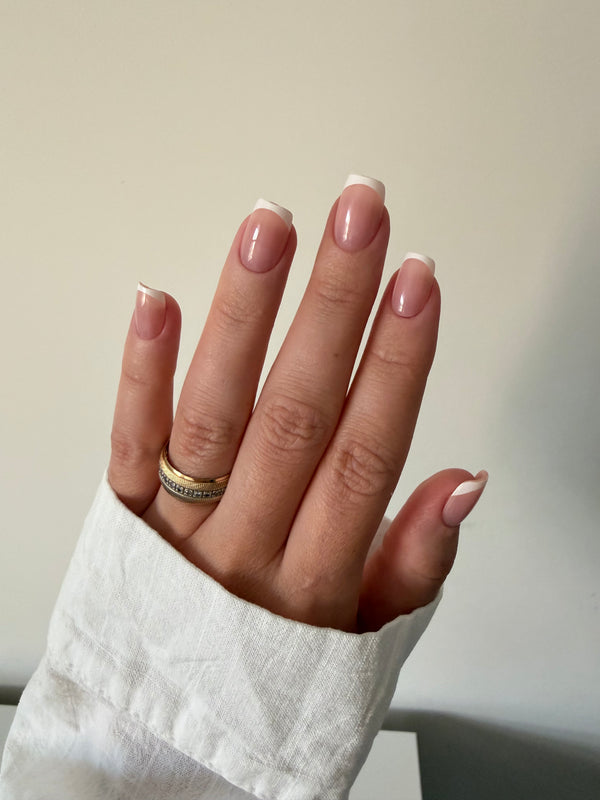 Classic French press-on nails on a hand, square short
