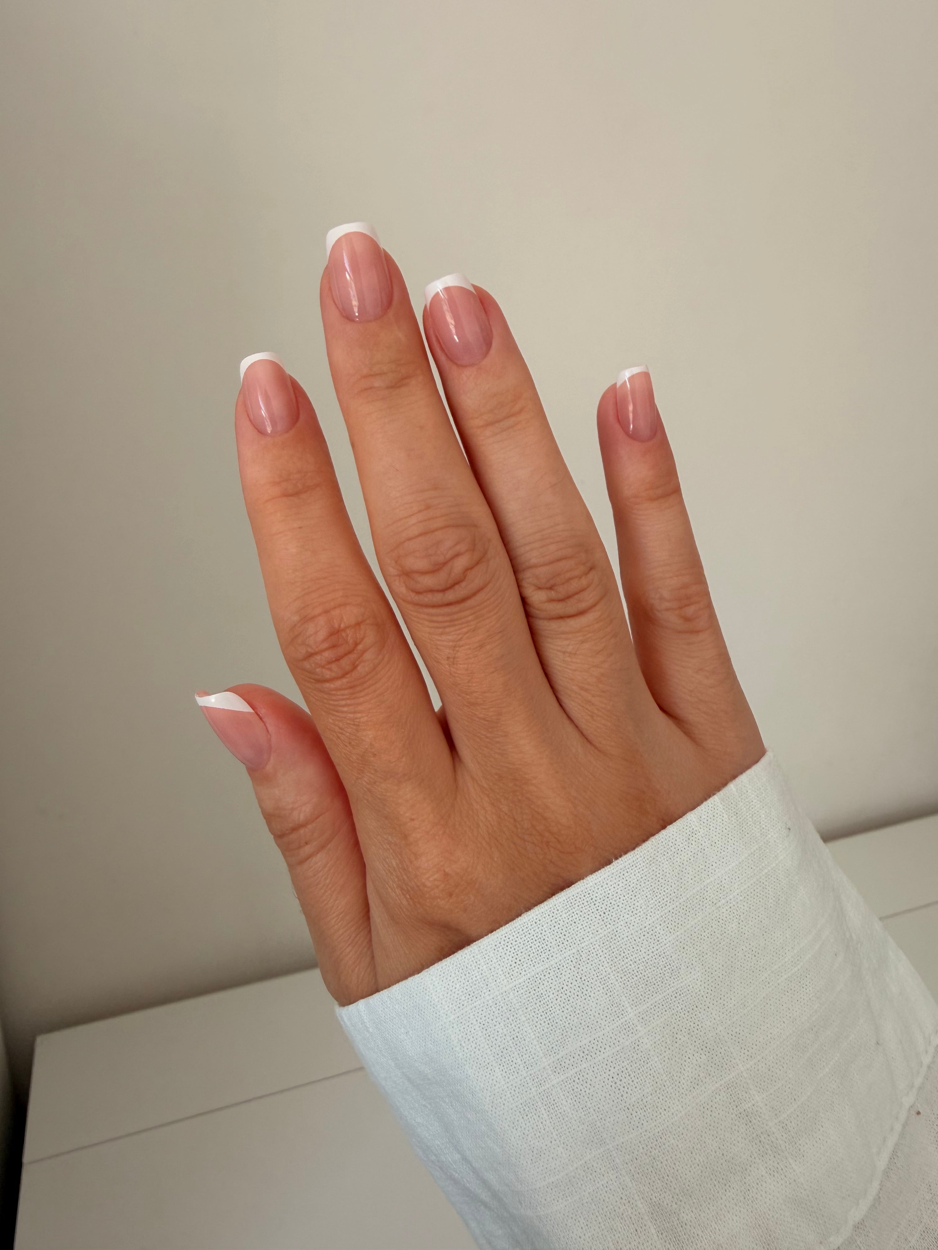 Classic French press-on nails on a hand, square short