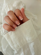 Classic French press-on nails on a hand, square short