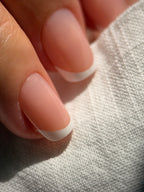 Classic French press-on nails on a hand, square short