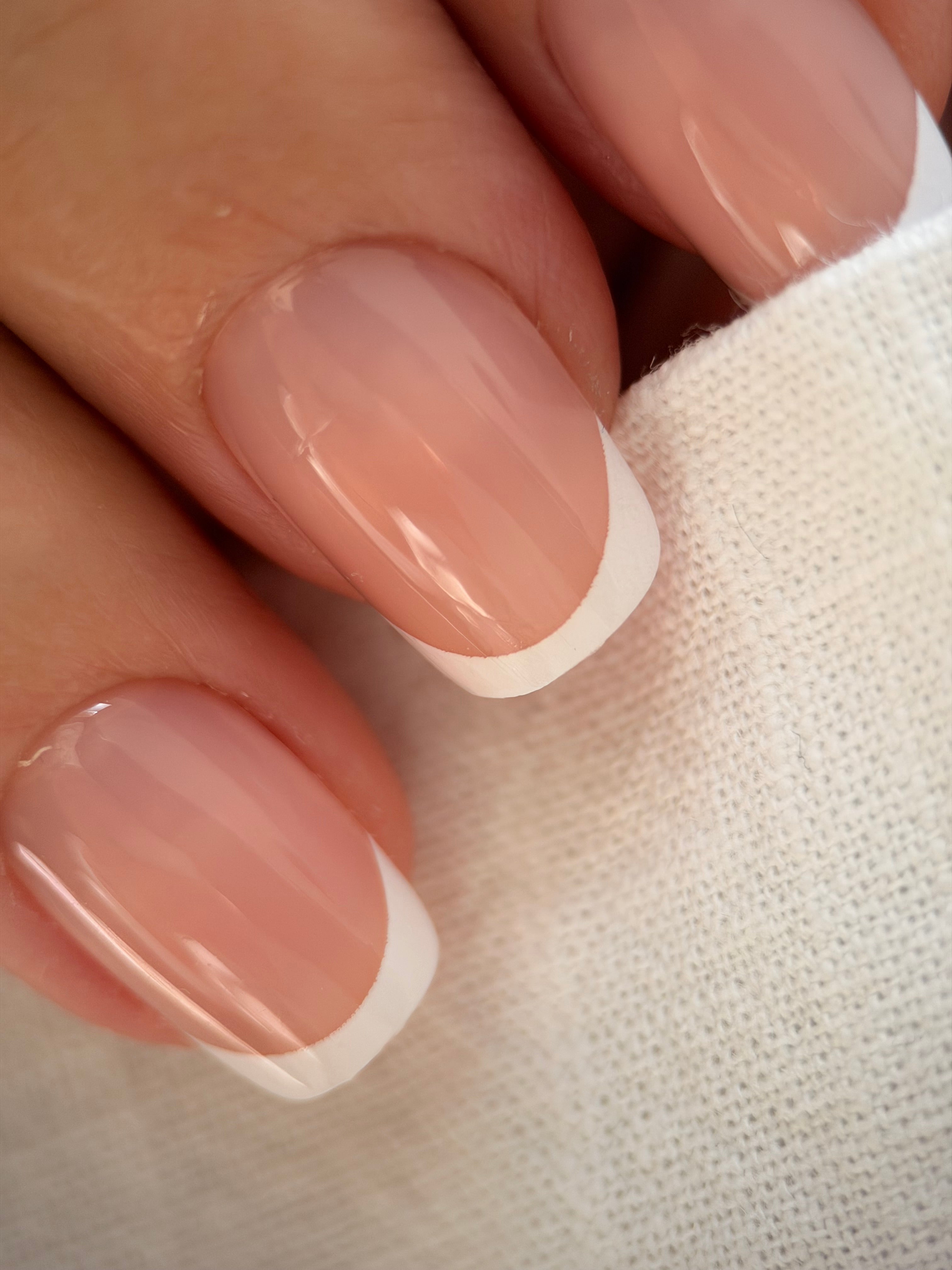 Classic French press-on nails on a hand, square short