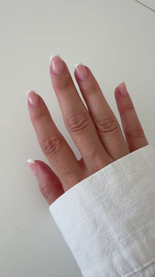 Classic French press-on nails on a hand, square short